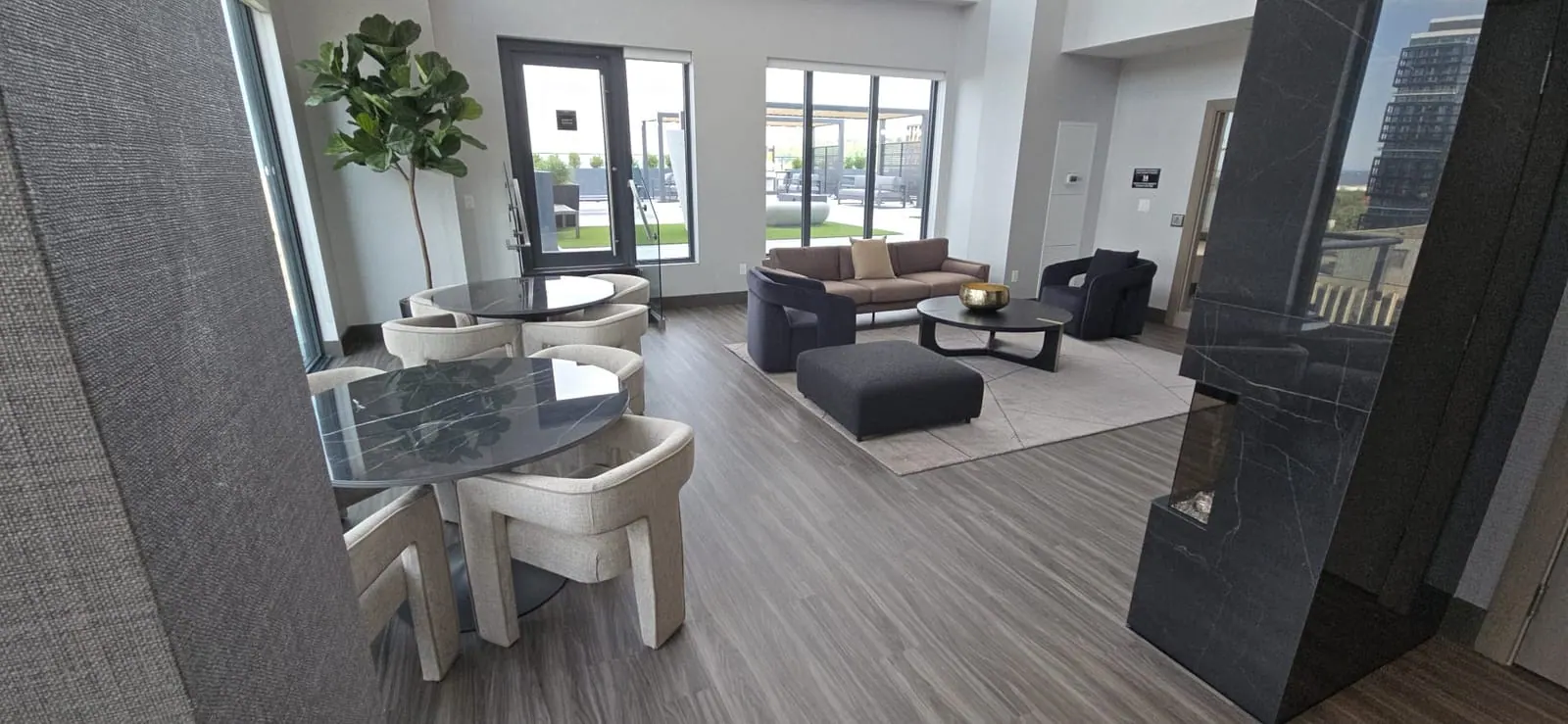 Indoor lounge with seating that opens onto the rooftop terrace